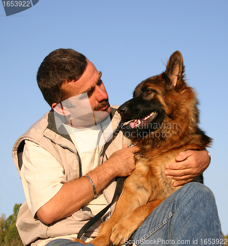 Image of german shepherd and man