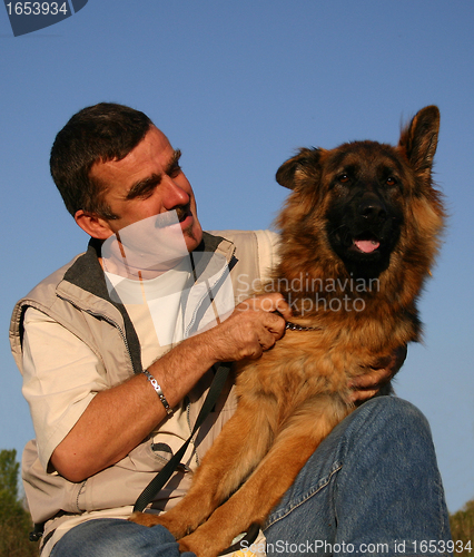 Image of german shepherd and man