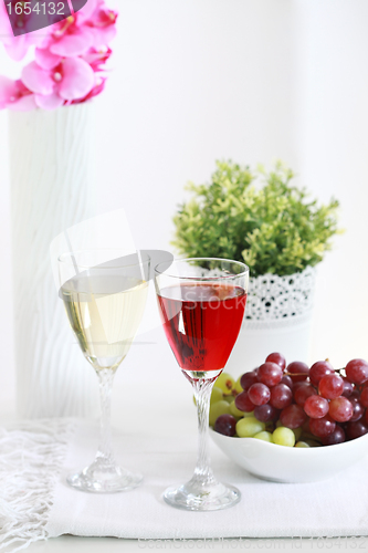 Image of Two glasses of wine with grapes