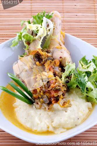 Image of Roasted chicken legs with mashed potatoes, vegetables saute and greens