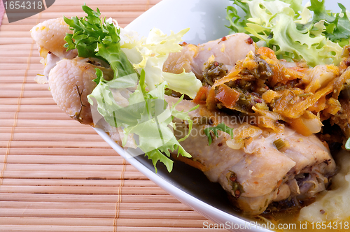 Image of Roasted chicken legs with mashed potatoes, vegetables saute and greens