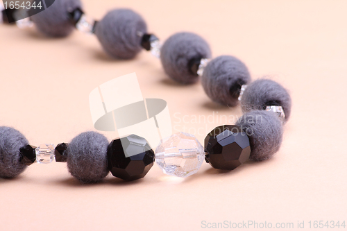 Image of Grey necklace at pink background
