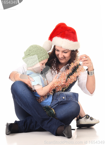 Image of Girl in a santa hat playing with a boy