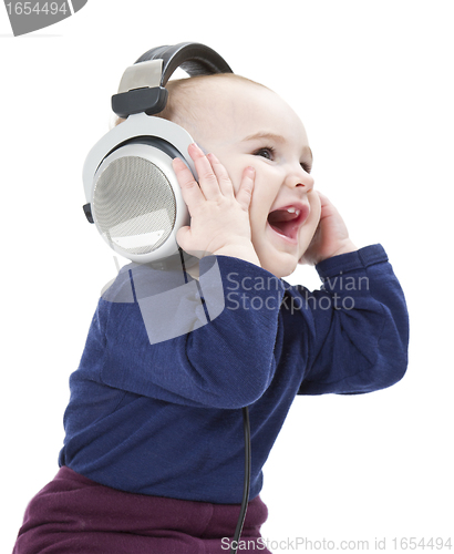 Image of young laughing child with ear-phones listening to music