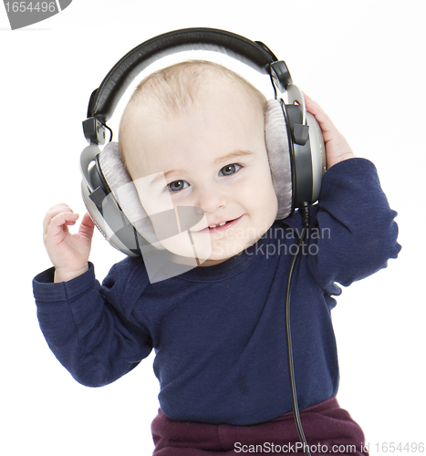 Image of young child with ear-phones listening to music