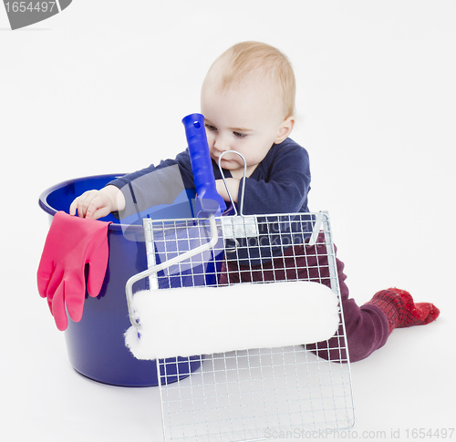 Image of young child with painters equipment