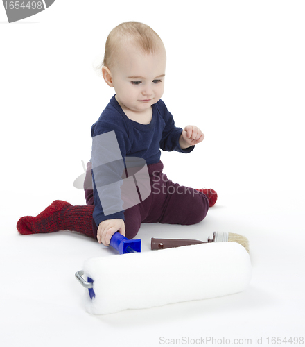 Image of young child with painters equipment