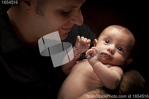 Image of Young Father Holding His Mixed Race Newborn Baby