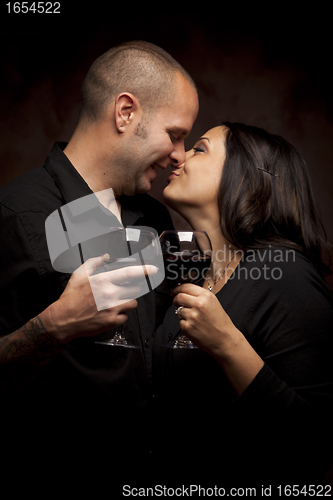 Image of Happy Mixed Race Couple Holding Wine Glasses