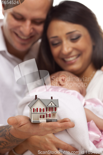 Image of Mixed Race Family with Small Model House