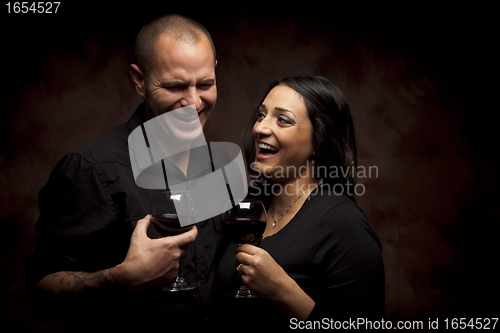 Image of Happy Mixed Race Couple Holding Wine Glasses