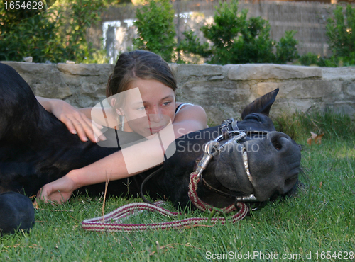 Image of horse laid down and riding girl