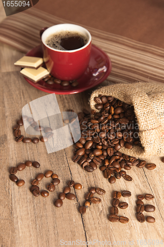 Image of Grains of coffee on a wooden surface