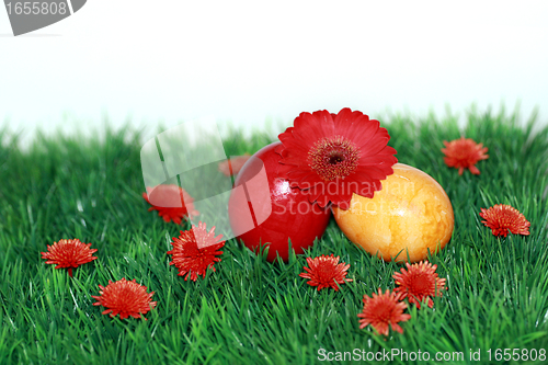 Image of Red flowers and colored eggs