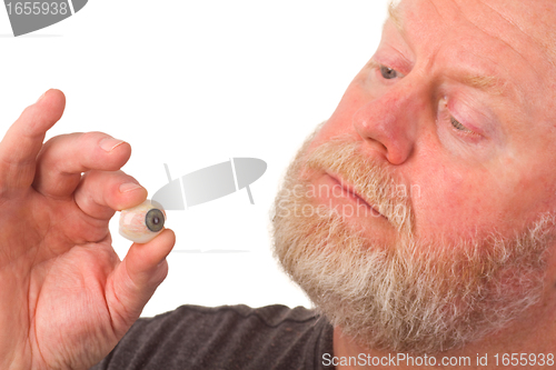 Image of Eye specialist holding glass eye