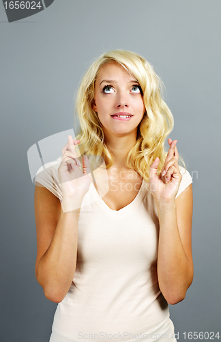Image of Hopeful woman crossing fingers