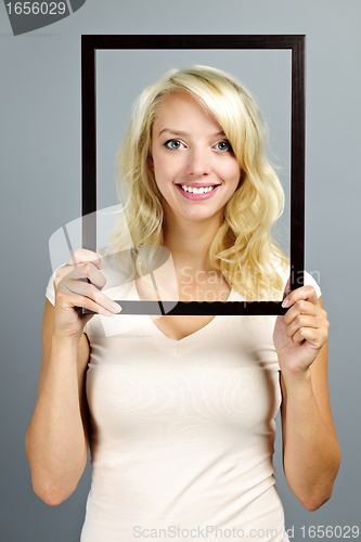 Image of Smiling woman with picture frame