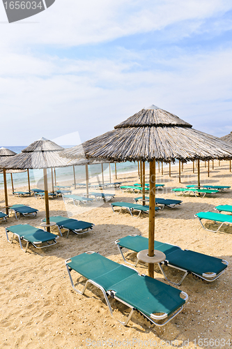 Image of Beach umbrellas on sandy seashore