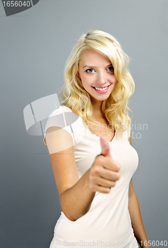 Image of Smiling woman giving thumbs up