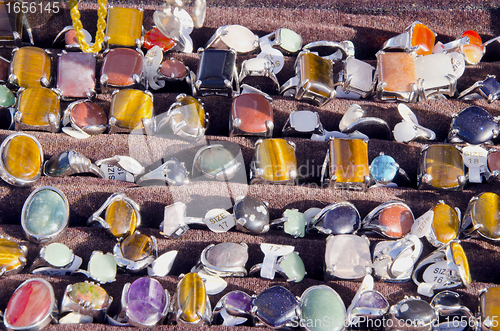 Image of rings from amber stones sold outdoor market fair 