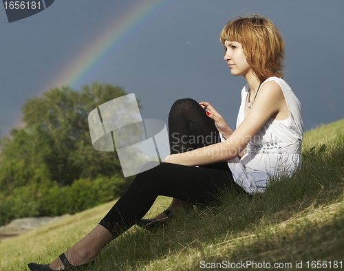Image of Attractive girl and rainbow