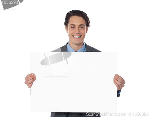 Image of Happy businessman showing an emty billboard