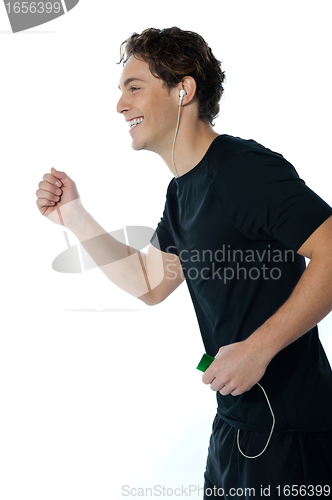 Image of Handsome sports person enjoying music