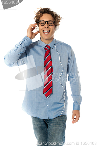 Image of Young man listening to music