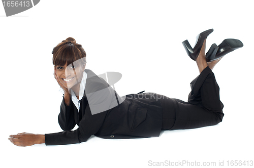 Image of Corporate woman lying on floor, smiling