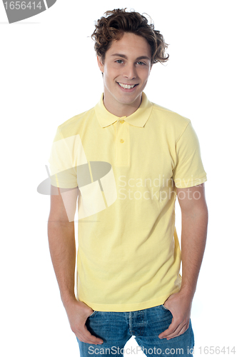 Image of Portrait of a stylish guy standing with hands in pockets