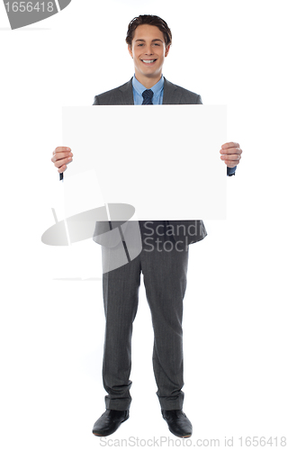 Image of Young businessman holds the blank billboard