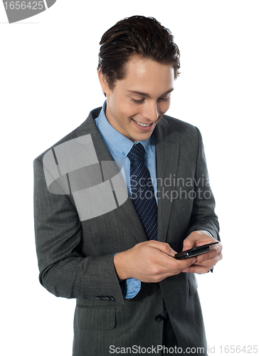 Image of Happy businessman using a mobile phone