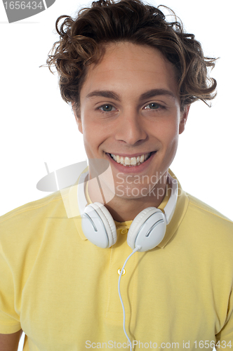 Image of Guy with headsets around his neck smiling at you