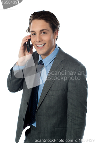 Image of Portrait of a smiling businessman using a cellphone