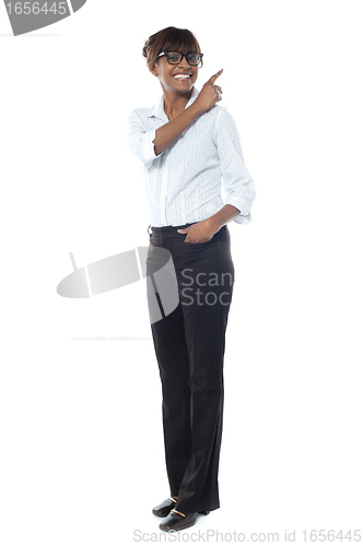 Image of Corporate smiling woman pointing away