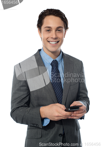 Image of Handsome businessman using a smartphone