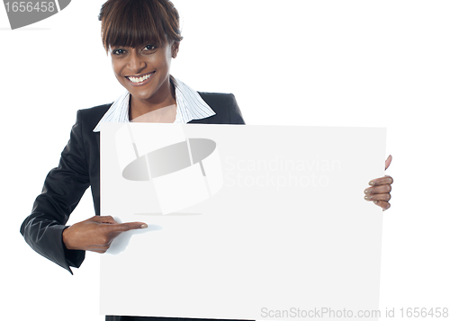 Image of Corporate female executive pointing towards blank banner
