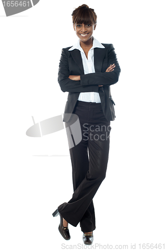 Image of Beautiful businesslady posing with legs crossed