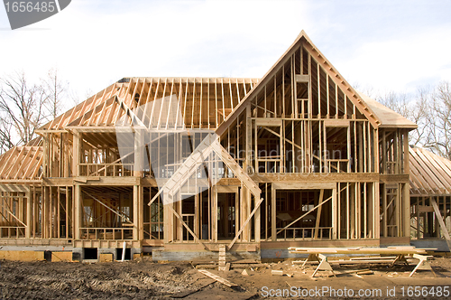 Image of McMansion type house under construction in framing phase