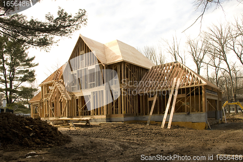 Image of McMansion type house under construction in framing phase