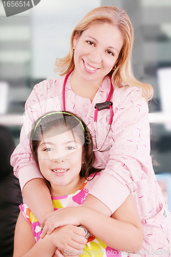 Image of Little cheerful girl visiting the doctor 