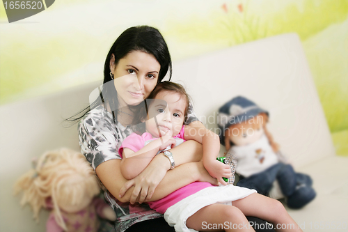 Image of Mother and daughter in the waiting room at doctors office.