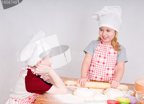 Image of girl and boy  in chef's hats