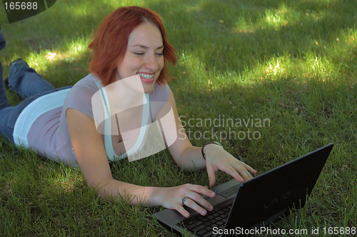 Image of Woman using laptop in park