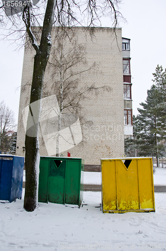 Image of snow cover plastic bins for sort waste in winter 