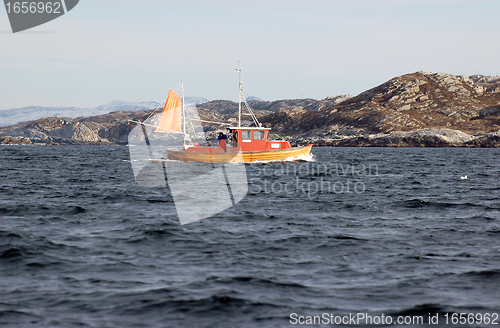 Image of old wooden boats on rocky seaside