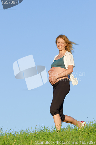 Image of pregnant woman on meadow