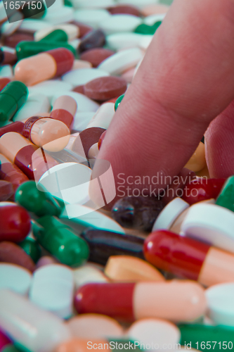 Image of hand grabbing pills