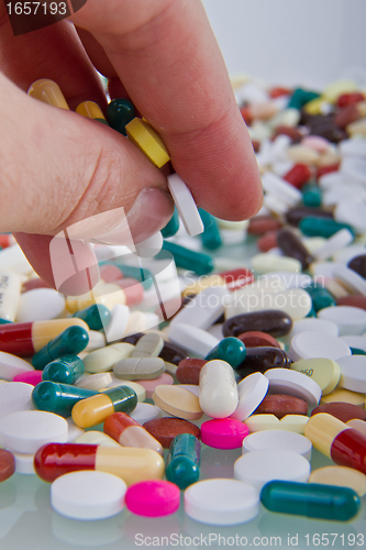 Image of hand grabbing pills