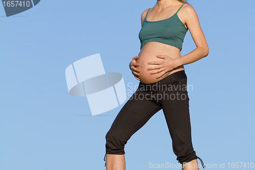 Image of pregnant woman on meadow